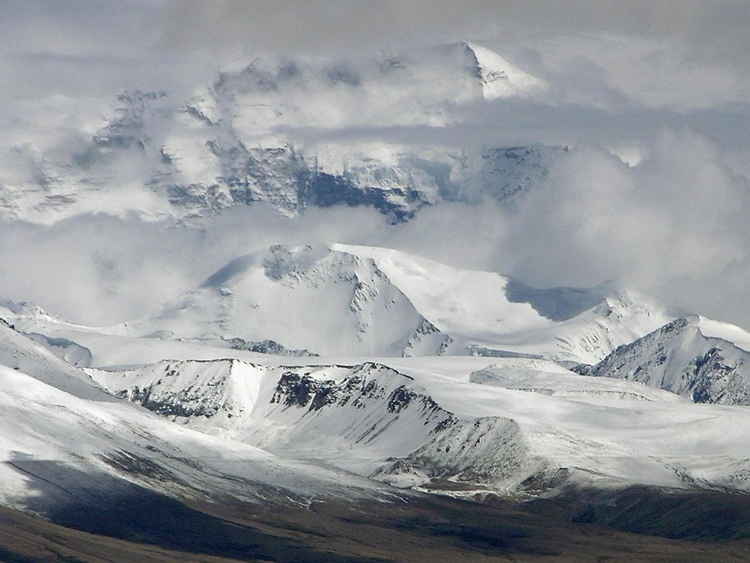 18 Cho Oyu Close Up In Monsoon Clouds Across the flooded plains of Tingri, Cho Oyu (8201m, sixth highest in the world) was partly visible in the monsoon clouds.